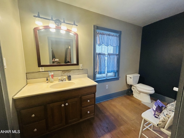 217 Good Shepherd Rd, Altoona, PA 16601 - half bath with backsplash, wood finished floors, toilet, vanity, and baseboards