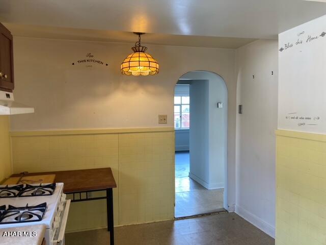 dining room with tile walls