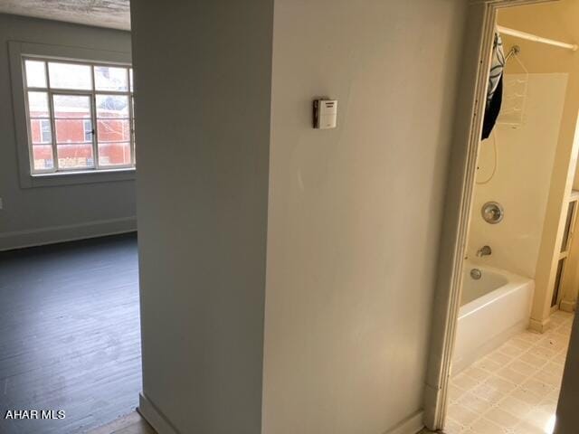 bathroom with shower / tub combination and hardwood / wood-style flooring