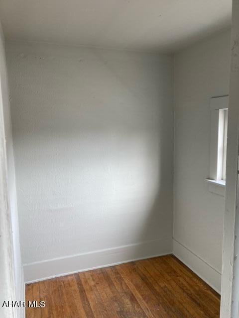 empty room featuring dark wood-type flooring