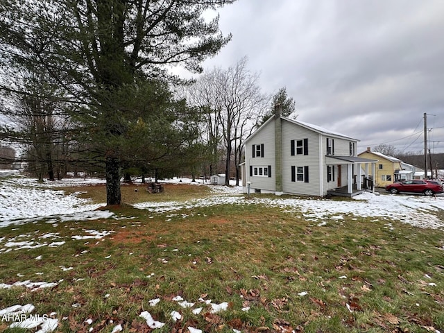 snow covered property with a yard