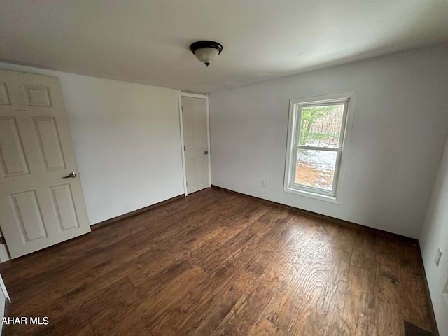 spare room with dark hardwood / wood-style flooring