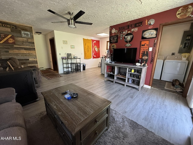 229 Celtic Ln, Altoona, PA 16601 - living area featuring a ceiling fan, electric panel, washing machine and dryer, and wood finished floors