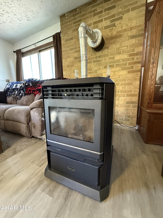 229 Celtic Ln, Altoona, PA 16601 - interior details featuring a textured ceiling, a wood stove, and wood finished floors