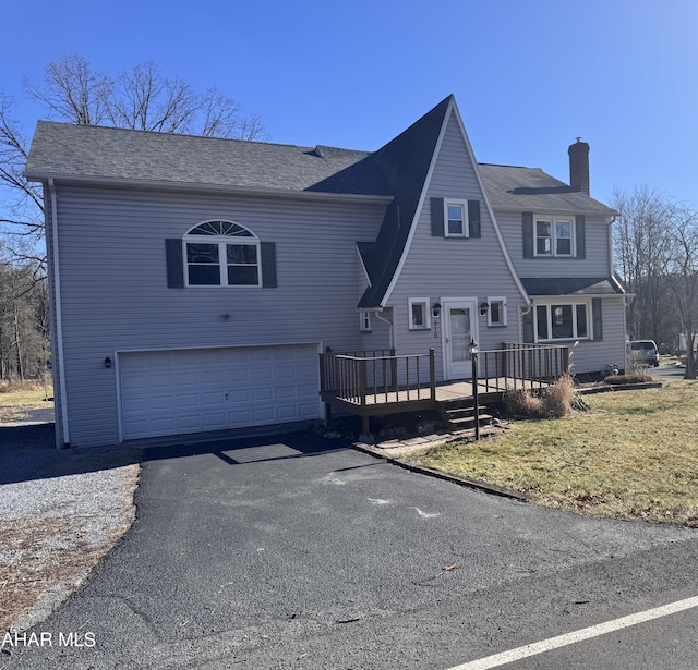 view of front of property featuring a wooden deck and a garage