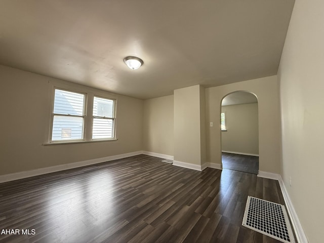 316 3rd Ave, Altoona, PA 16602 - unfurnished room featuring arched walkways, healthy amount of natural light, and dark wood-style floors