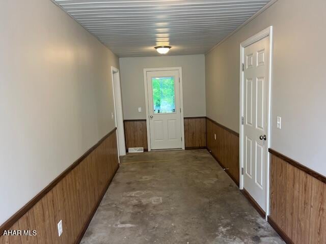 208 W 5th Ave, Everett, PA 15537 - hallway featuring wood walls, wainscoting, and unfinished concrete floors