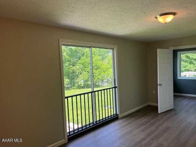 208 W 5th Ave, Everett, PA 15537 - unfurnished room with a textured ceiling and dark wood-type flooring