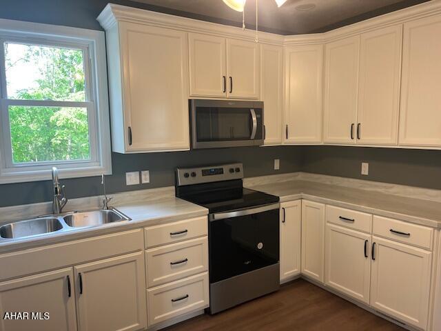 208 W 5th Ave, Everett, PA 15537 - kitchen with stainless steel range with electric stovetop, light countertops, plenty of natural light, and white cabinetry