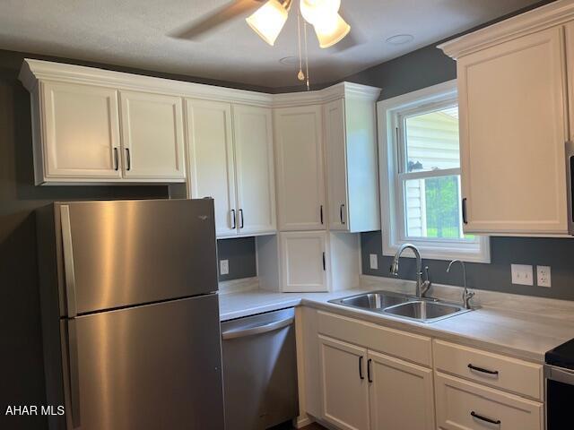 208 W 5th Ave, Everett, PA 15537 - kitchen with stainless steel appliances, light countertops, ceiling fan, and white cabinets