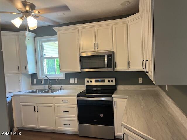 208 W 5th Ave, Everett, PA 15537 - kitchen with appliances with stainless steel finishes, white cabinetry, light countertops, and ceiling fan