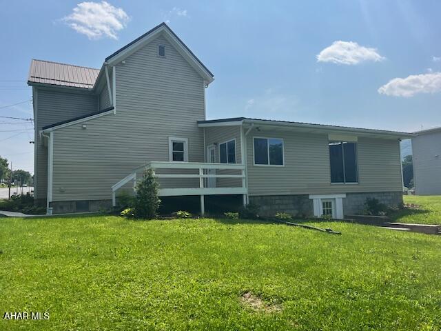 208 W 5th Ave, Everett, PA 15537 - rear view of house with a yard, a metal roof, a wooden deck, and a standing seam roof