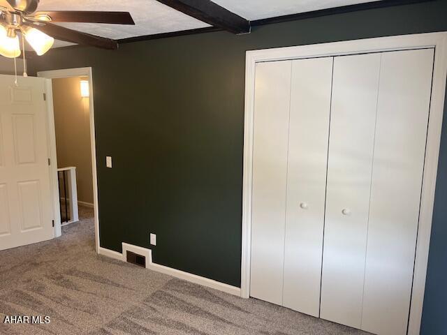 208 W 5th Ave, Everett, PA 15537 - unfurnished bedroom featuring carpet, beam ceiling, a closet, and ceiling fan