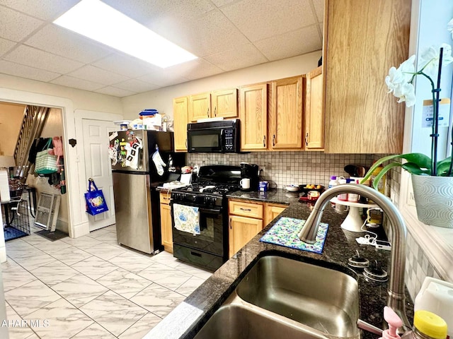 311 E Bell Ave, Altoona, PA 16602 - kitchen with black appliances, light marble finish flooring, a paneled ceiling, light brown cabinetry, and dark stone counters