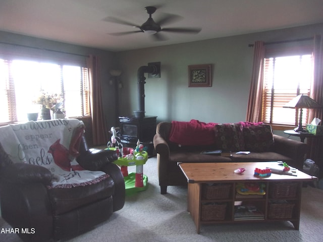 3752 Main Rd, Bedford, PA 15522 - living room with carpet floors, healthy amount of natural light, ceiling fan, and a wood stove