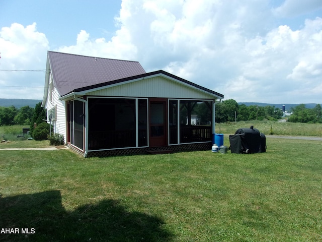 3752 Main Rd, Bedford, PA 15522 - rear view of property featuring a sunroom and a lawn