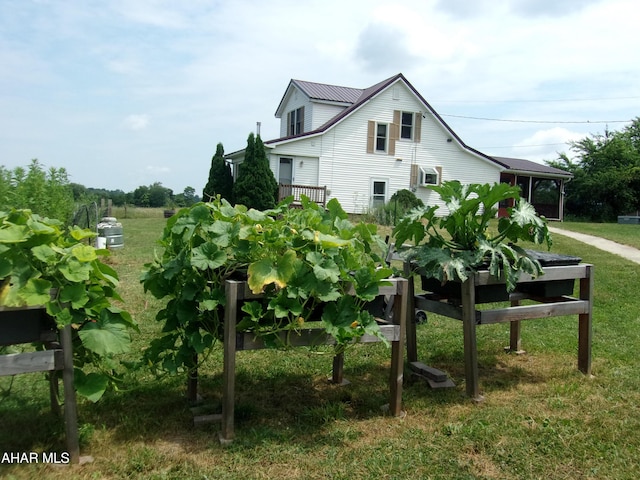 3752 Main Rd, Bedford, PA 15522 - view of side of property with a lawn, a garden, and a metal roof