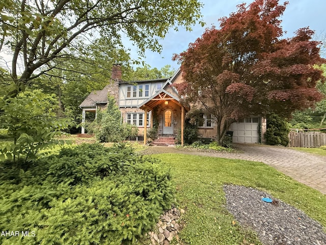 5 Log Cabin Ct, Altoona, PA 16602 - tudor house featuring driveway, a chimney, a garage, and stone siding
