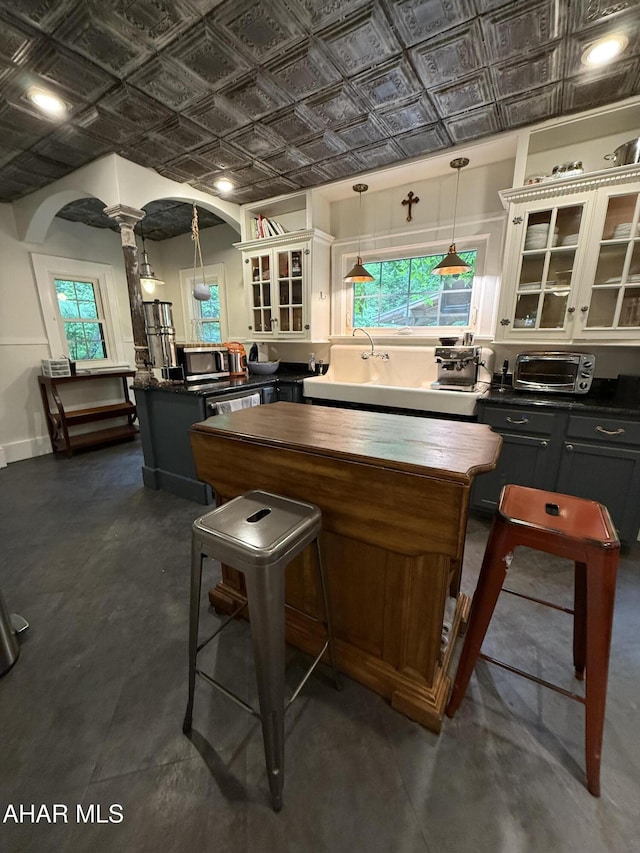 5 Log Cabin Ct, Altoona, PA 16602 - kitchen featuring an ornate ceiling, a peninsula, glass insert cabinets, white cabinets, and a center island