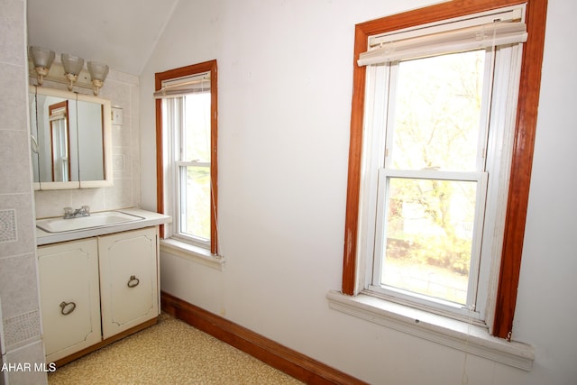 bathroom with vanity and vaulted ceiling