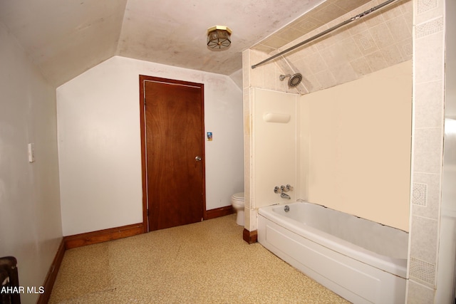 bathroom with toilet, washtub / shower combination, and vaulted ceiling