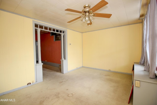 carpeted empty room featuring ceiling fan