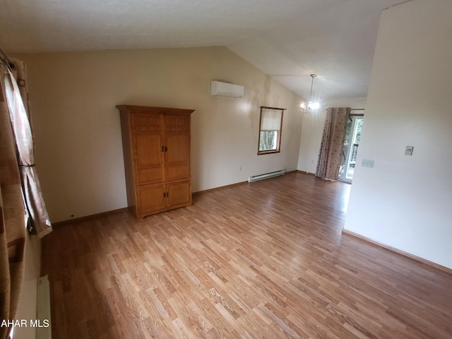 spare room featuring a baseboard radiator, a notable chandelier, a wall mounted AC, lofted ceiling, and light wood-type flooring