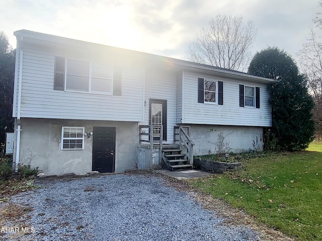 split foyer home with a front lawn