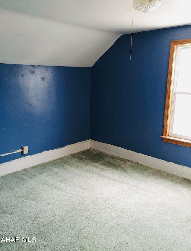 additional living space featuring carpet floors and lofted ceiling