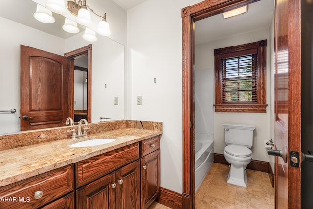 bathroom featuring tile patterned flooring, vanity, toilet, and a tub