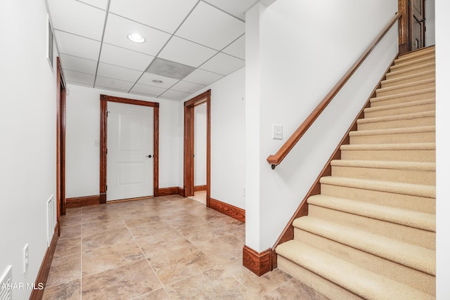 foyer featuring a drop ceiling