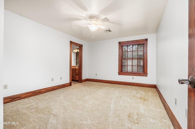 carpeted spare room featuring ceiling fan