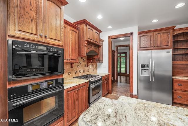 kitchen with decorative backsplash, light stone countertops, premium range hood, stainless steel appliances, and light tile patterned floors