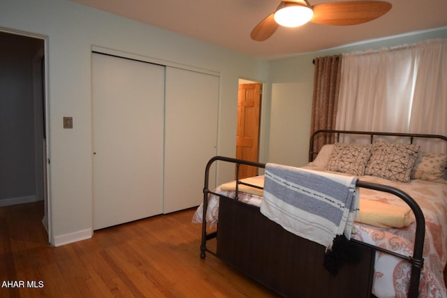 bedroom with hardwood / wood-style flooring, a closet, and ceiling fan