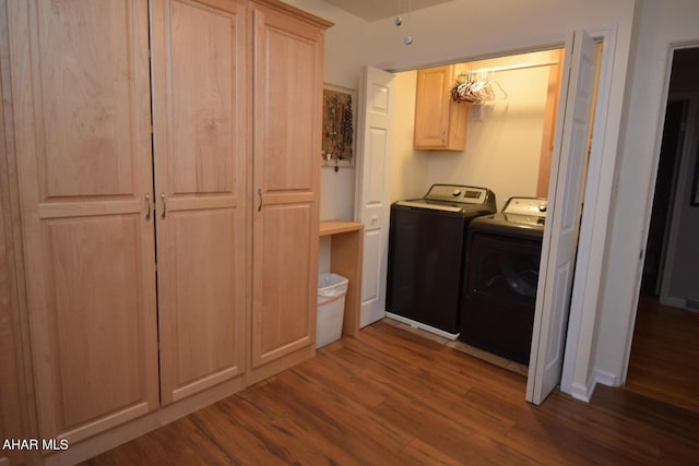 washroom with cabinets, separate washer and dryer, and dark hardwood / wood-style floors