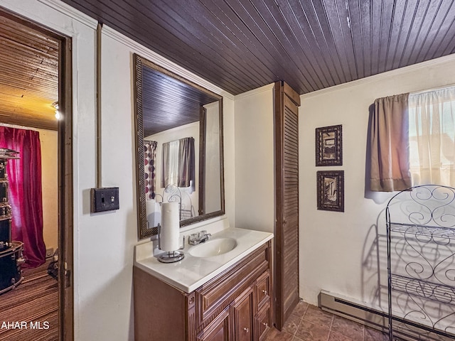 bathroom with baseboard heating, tile patterned flooring, crown molding, vanity, and wood ceiling