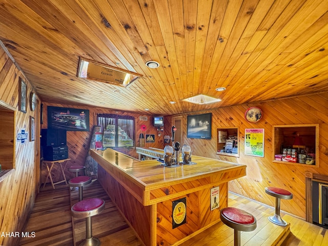 bar featuring wood walls, wood-type flooring, and wood ceiling