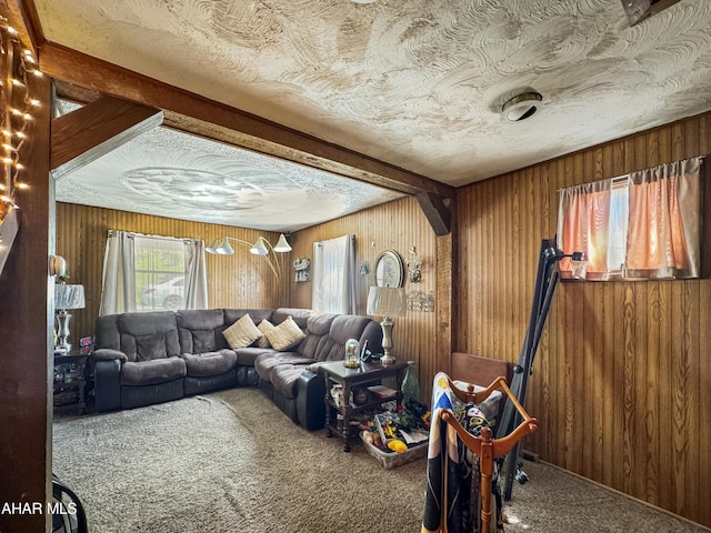 carpeted living room with wood walls and beam ceiling