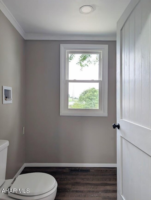 bathroom featuring crown molding, wood-type flooring, and toilet