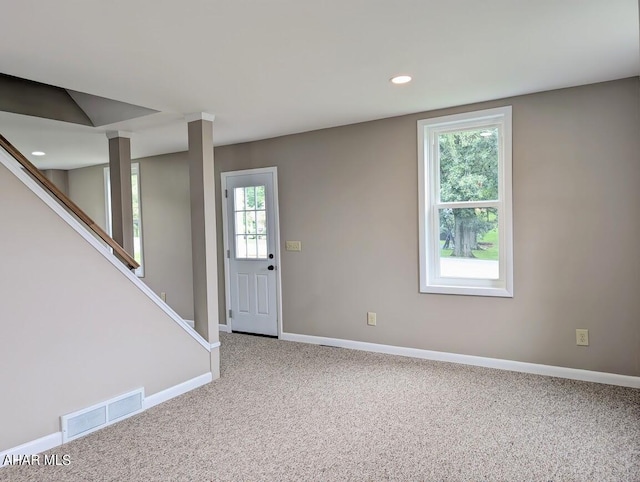 foyer entrance featuring carpet and a healthy amount of sunlight