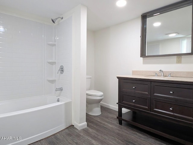 full bathroom featuring hardwood / wood-style floors, vanity, toilet, and tiled shower / bath