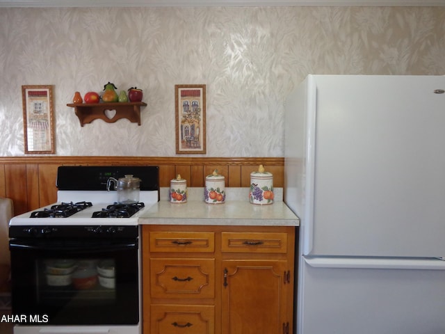 kitchen featuring gas range and white fridge