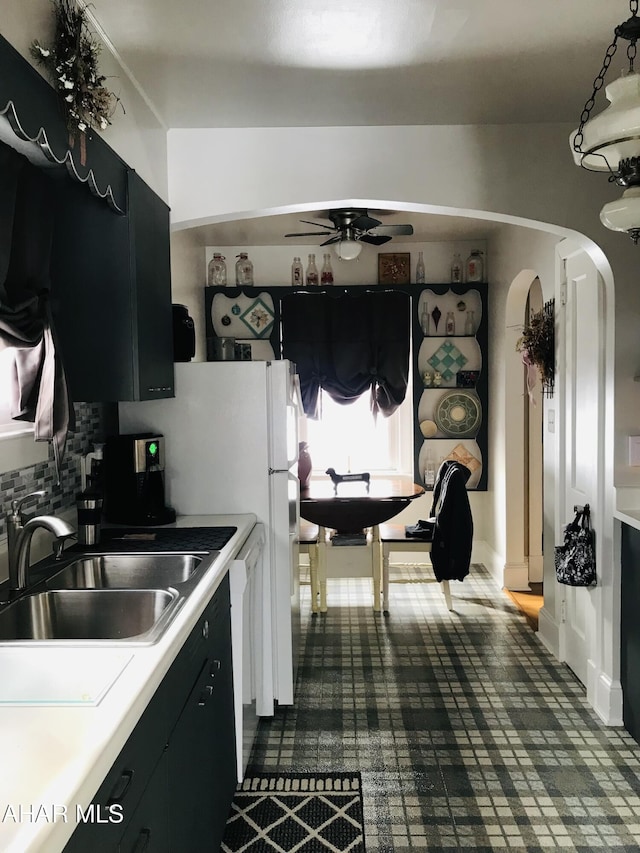 kitchen with dishwasher, sink, pendant lighting, and ceiling fan