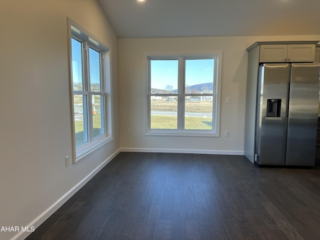 interior space with plenty of natural light, dark wood-type flooring, and vaulted ceiling