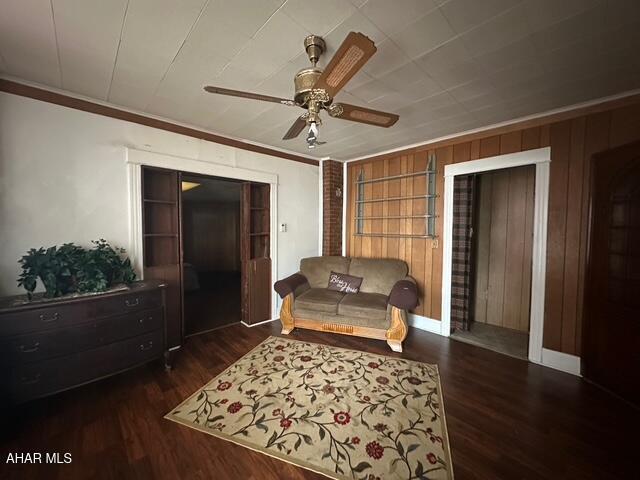 600 N 6th Ave, Altoona, PA 16601 - living area with ceiling fan, wood finished floors, ornamental molding, and wood walls