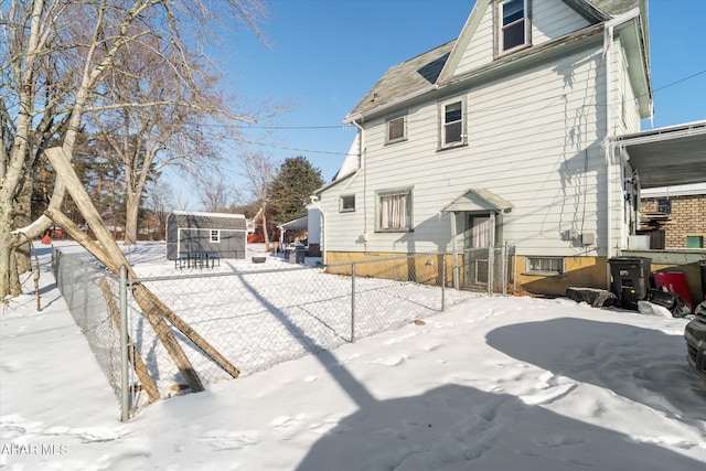 view of snow covered back of property