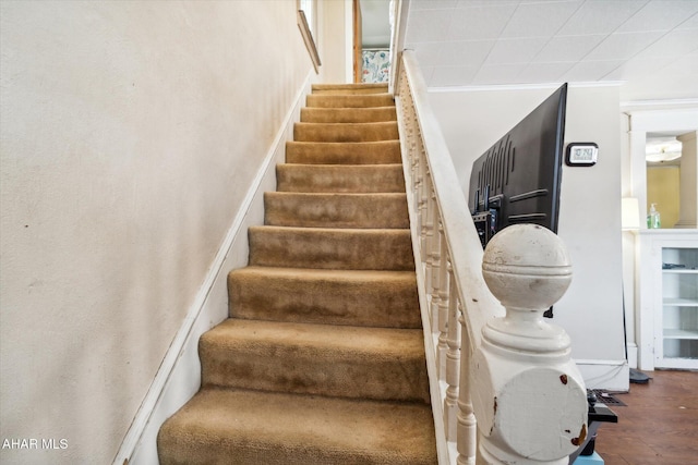 staircase featuring ornamental molding