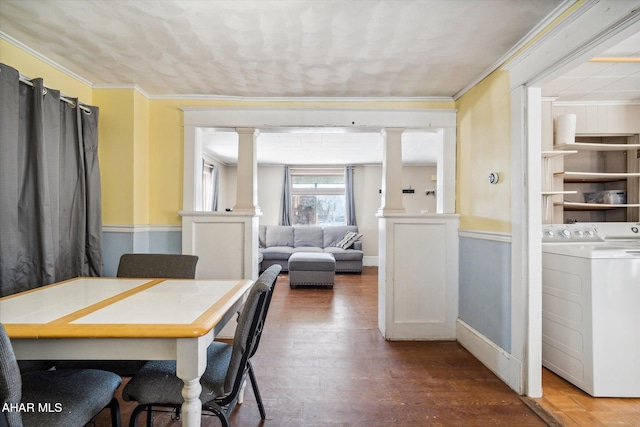 dining area featuring ornamental molding, decorative columns, and dark hardwood / wood-style floors