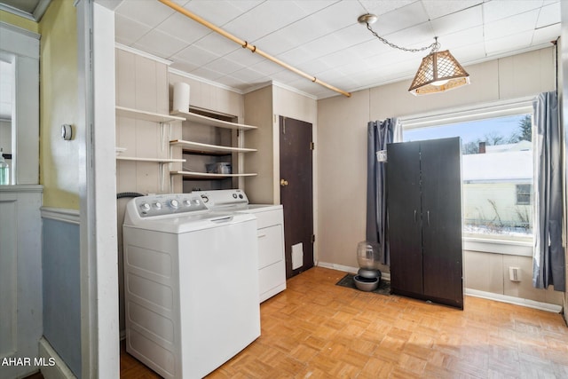 laundry room with washer and clothes dryer and light parquet floors