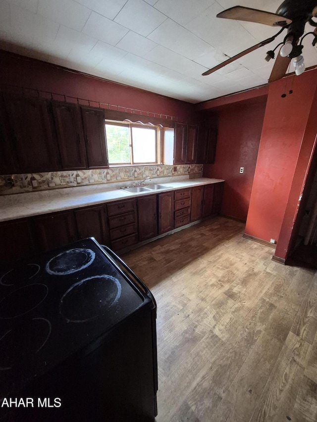 1302 3rd Ave, Altoona, PA 16602 - kitchen with electric range oven, a ceiling fan, light countertops, and light wood finished floors